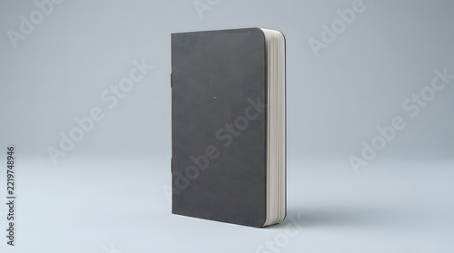 A professional book mockup featuring a standing dark grey hardcover book isolated against a clean light grey studio background