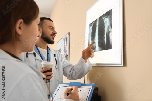 Medical diagnosis and healthcare collaboration, doctors reviewing chest x-ray...