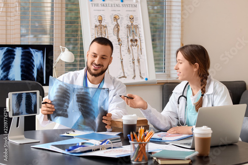 Medical consultation and diagnosis, doctors reviewing chest x-ray in hospital...