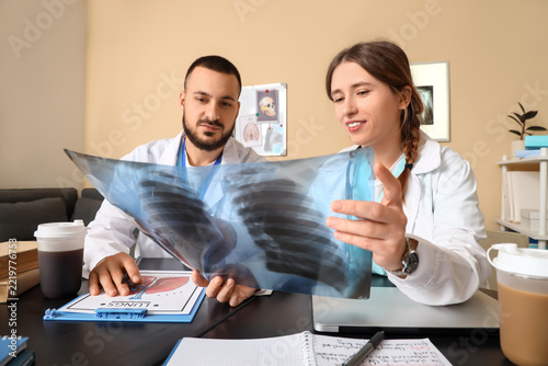 Medical diagnosis and healthcare collaboration, doctors examining chest x-ray...