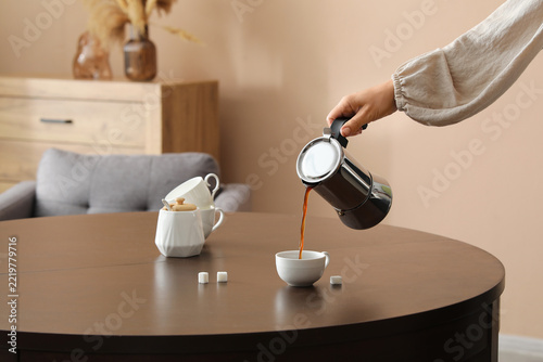 Obraz na plátně Morning routine and coffee break, person pouring fresh hot espresso from a moka