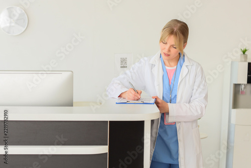 Healthcare administration and medical record keeping, nurse or doctor writing...