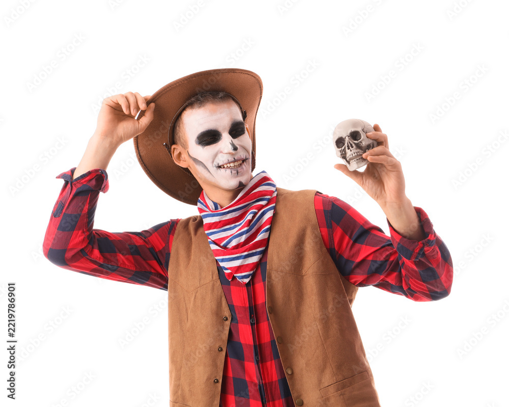 Fototapeta premium Halloween celebration and costume party, man in cowboy outfit with skull makeup holding a small human skull isolated on a white background
