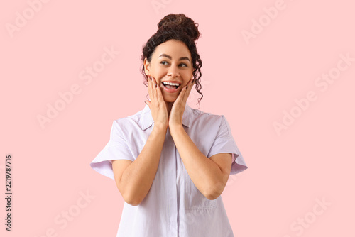 Surprise and excitement, happy young woman with hands on face looking away on...