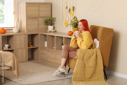 Cozy autumn lifestyle and mental wellness, woman relaxing in armchair with ho...