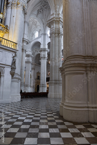 Checkered marble floor and white columns in Granada Cathedral nave