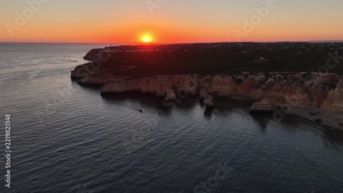 Sunset over stunning cliffs and arches Algarve, Portugal 