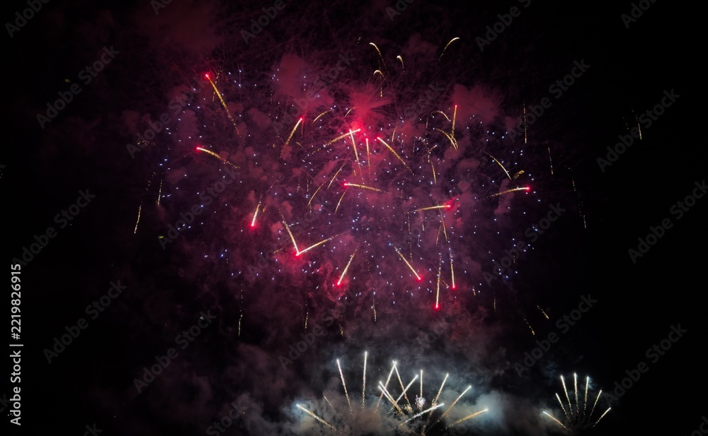 Fototapeta premium Colorful fireworks over cityscape at new year night