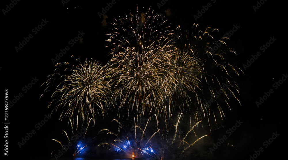 Fototapeta premium Colorful fireworks over cityscape at new year night