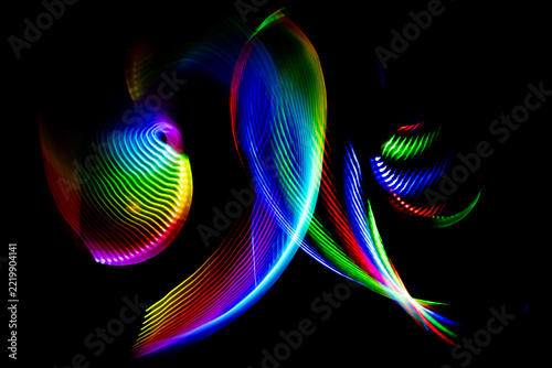 Colorful swirling light painting with led trails on black background