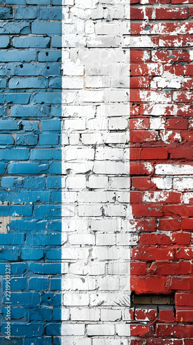 Brick wall painted with the colors of the French national flag features a weathered and rustic texture.