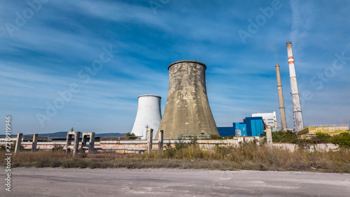 Industrial thermal power plant with cooling towers and smokestacks under blue sky in Eastern Europe, Varna, Bulgaria