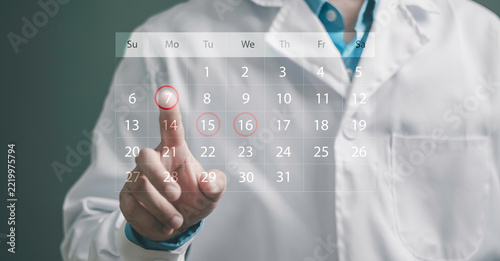 Medical appointment, scheduled consultations, health checkups, patient reminders, and preventive healthcare. Doctor highlighting dates on a digital calendar dashboard.