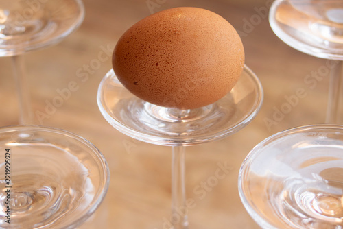 Fresh raw egg on inverted glass stemware
