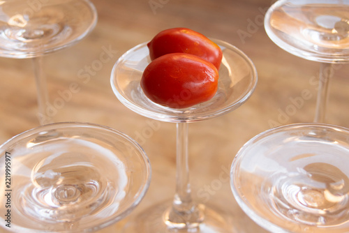 Fresh ripe tomatoes on inverted cocktail glass