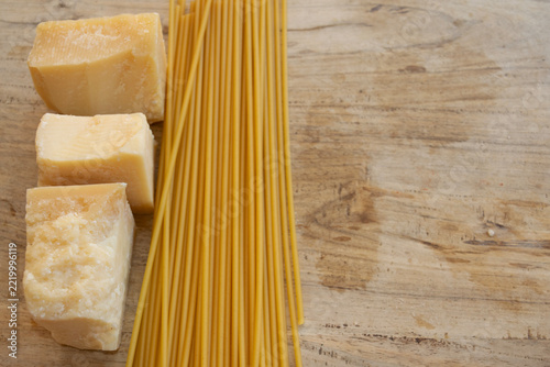 Raw spaghetti and parmesan cheese