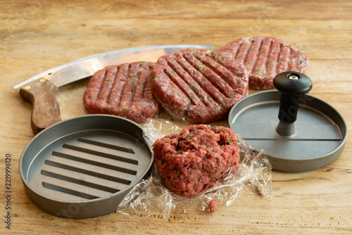 raw beef burger patties with press tool