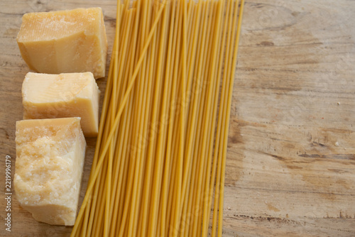 Raw spaghetti and parmesan cheese
