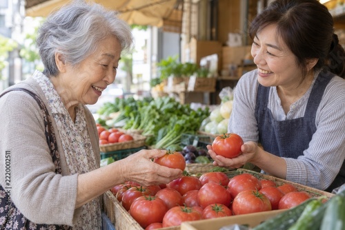 Senior woman shopping for fresh tomatoes at local farmer's market
