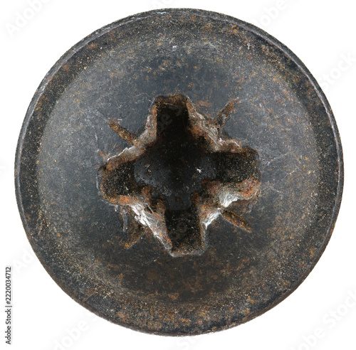 Oxidized metal plaque with a central cruciform cutout showing signs of age