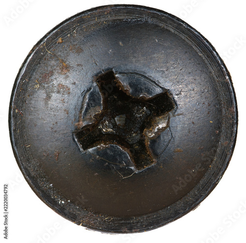 Circular metal piece exhibiting significant reddish-brown rust and central cross recess