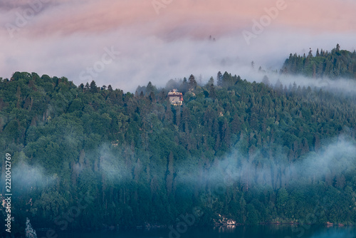 Majestic panoramic view of the Tatra Mountains landscape featuring snow-capped peaks, colorful forests, and picturesque valleys under a dramatic sky. Beautiful scenic nature and wilderness background