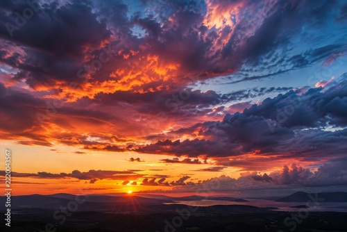 Vivid Orange and Magenta Sunset Light across Dark and Dramatic Clouds