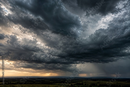 Heavy storm clouds gathering over a distant rural horizon before rain