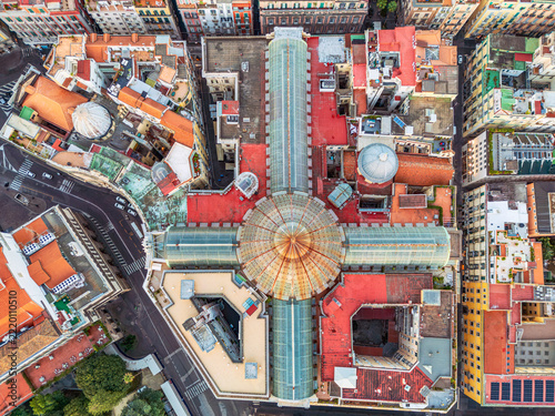 Umberto Gallery aerial top view. NAPLES, ITALY - OCTOBER 3, 2026: Top-down aerial view of Galleria Umberto I featuring its grand glass dome, cross-shaped structure, and surrounding rooftops.
