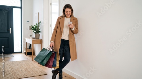 Stylish Young Woman Holding Shopping Bags and Checking Smartphone Discount After Black Friday Sale