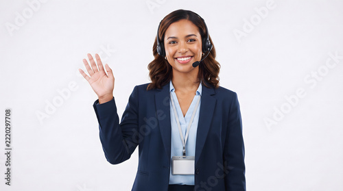 Smiling customer service representative wearing headset waving hand against white studio background