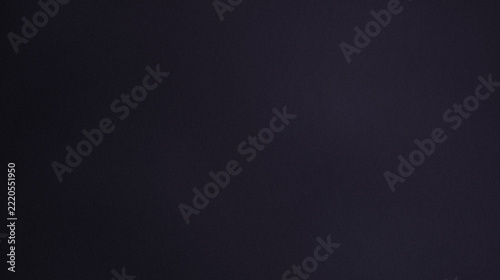 Dark grainy violet background with radial gradient, soft light, high contrast and subtle film noise texture for abstract minimal backdrop designs