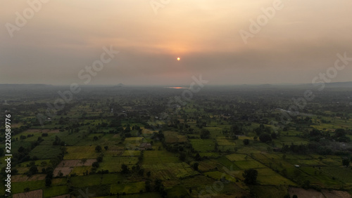 Beautiful aerial video of sunset with farm land.