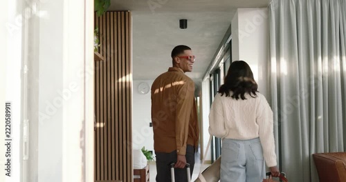 African American couple entering front door, pulling suitcase, carrying yoga mat, reuniting at home