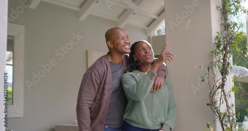 African American couple entering foyer noting column and window showing redfob keys claiming home