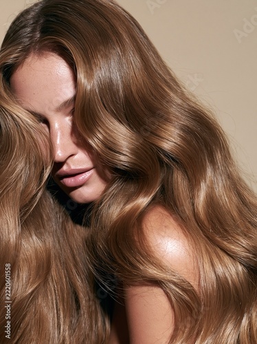 Glossy long wavy brown hair in close-up beauty portrait