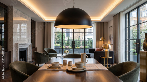 Modern matte black dome pendant light in a minimalist luxury kitchen.