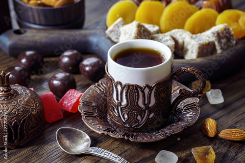 Turkish coffee and sweets arranged on decorative wooden tray