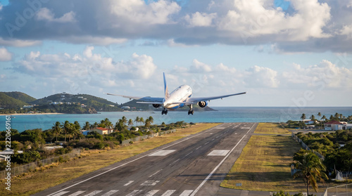 Passenger Aircraft Lifting Off From a Coastal Runway in Warm Sunlight
