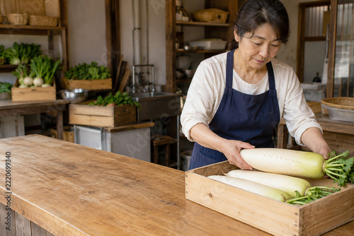 Woman arranging fresh daikon radishes in a wooden produce crate
