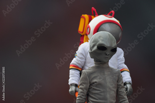 Alien captured by an astronaut in background blur, parody