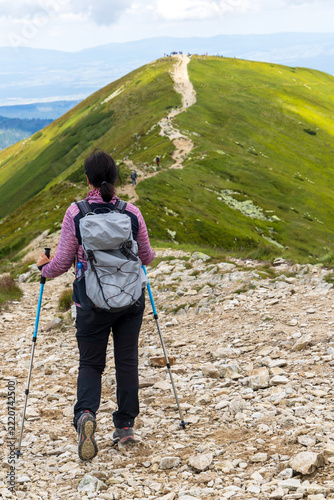 Fotografie Hiker Trekking Up Rocky Path on Mountain Ridge