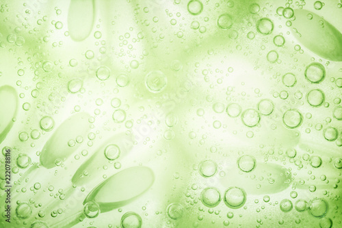 Macro green cucumber slices in sparkling water background banner