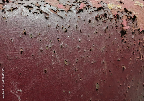 Close up of damaged old brown faux leather texture with peeling surface
