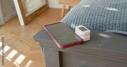 Red phone and white device are centering as camera is sliding right, sunlight shifting reflections