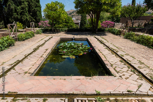 Obraz na plátně Rectangular reflecting pool and brick courtyard ruins of the Upper Partal Palace