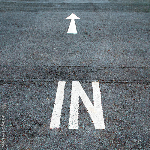 Arrow with in traffic direction sign painted on the road