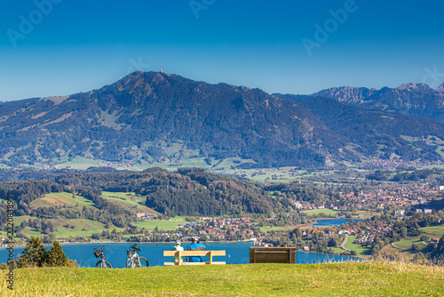 Germany, Bavaria, Allgaeu, couple enjoying the view over Alpsee and Gruenten mountain