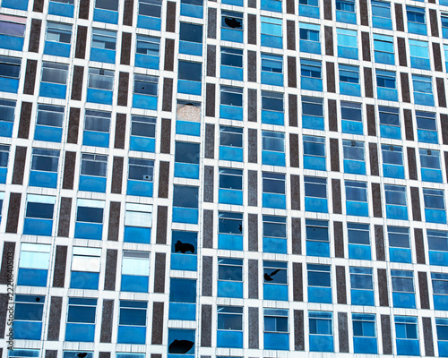 Damaged windows of abandoned modern office building