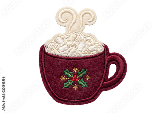 Embroidered patch of a hot cocoa mug with marshmallows and festive holly on transparent background